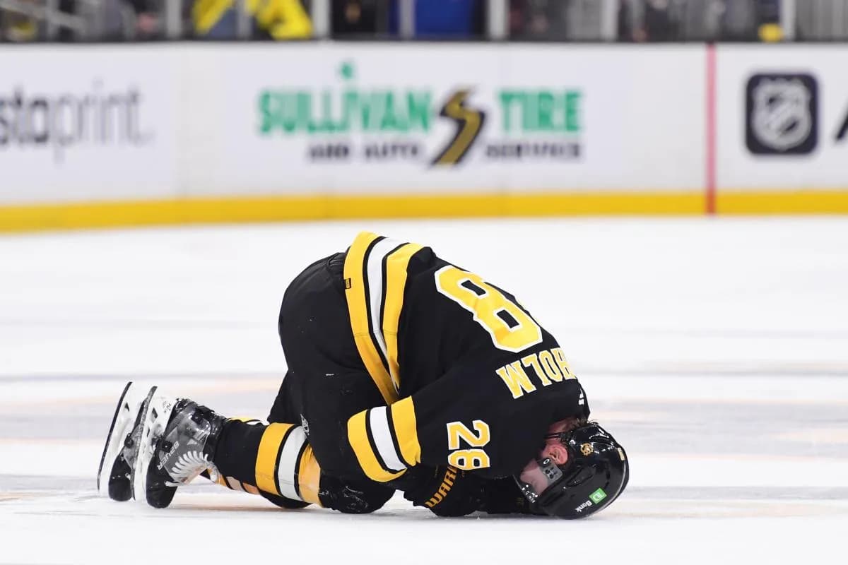Boston Bruins center Elias Lindholm (28) on the ice after an apparent injury during the second period against the Buffalo Sabres at TD Garden.
