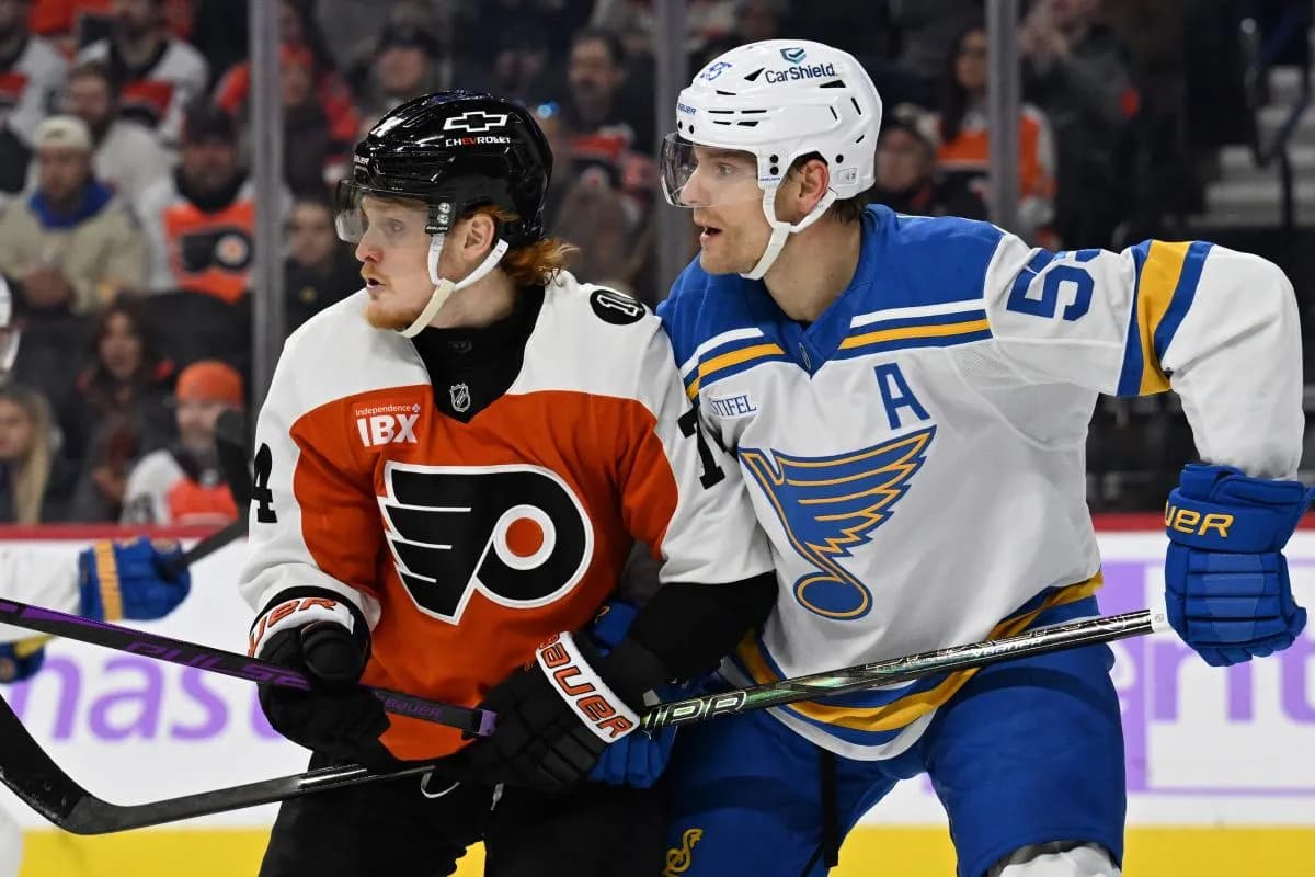 St. Louis Blues defenseman Colton Parayko (55) and Philadelphia Flyers right wing Owen Tippett (74) battle for position at Xfinity Mobile Arena.