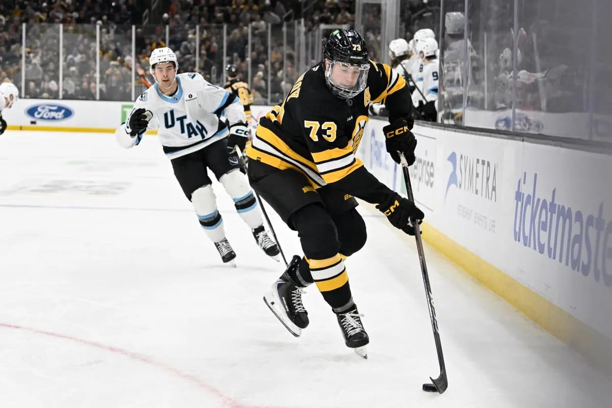 Boston Bruins defenseman Charlie McAvoy (73) plays the puck along the boards during the second period against the Utah Mammoth at TD Garden.