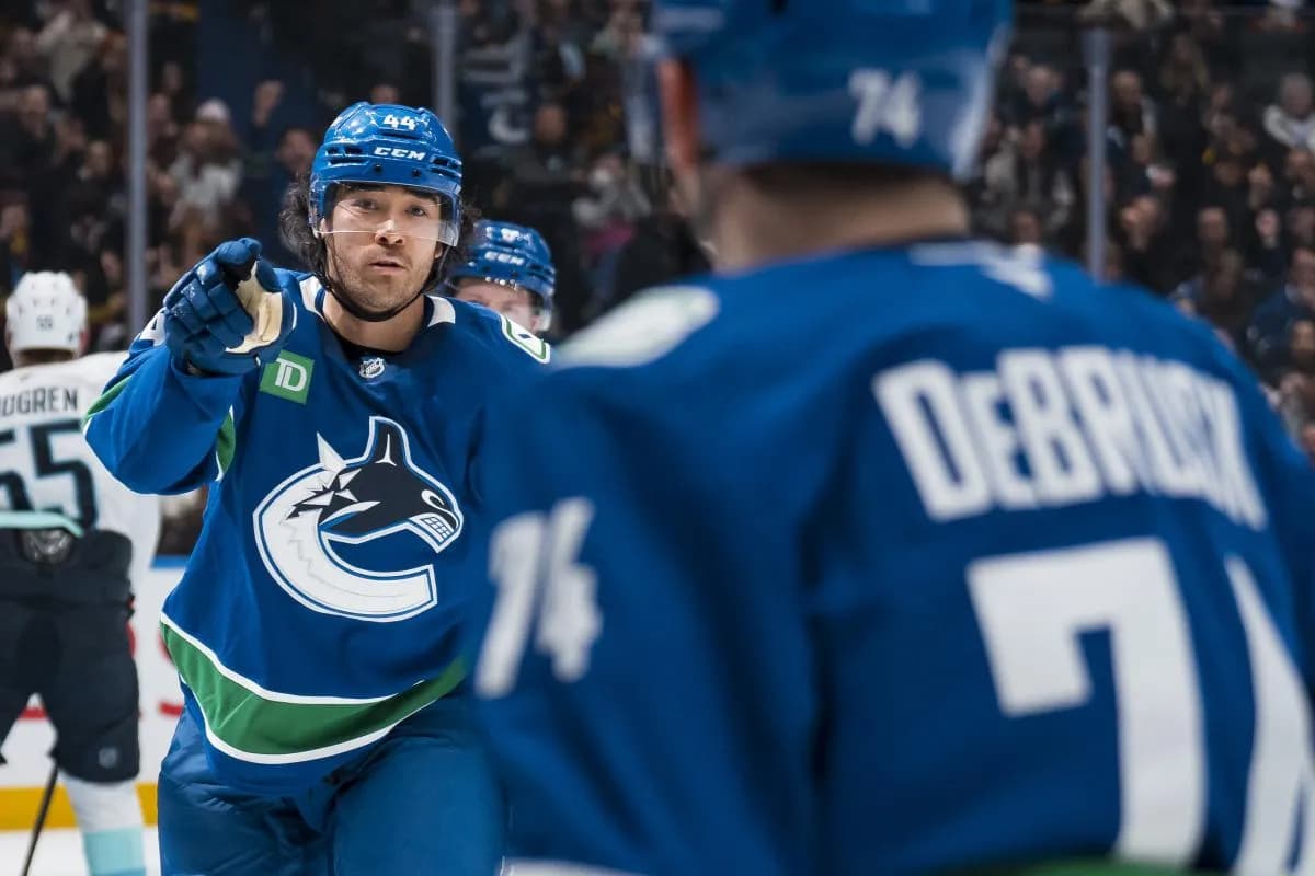 Vancouver Canucks forward Kiefer Sherwood (44) and forward Jake DeBrusk (74) celebrate Sherwood's goal against the Seattle Kraken in the second period at Rogers Arena.