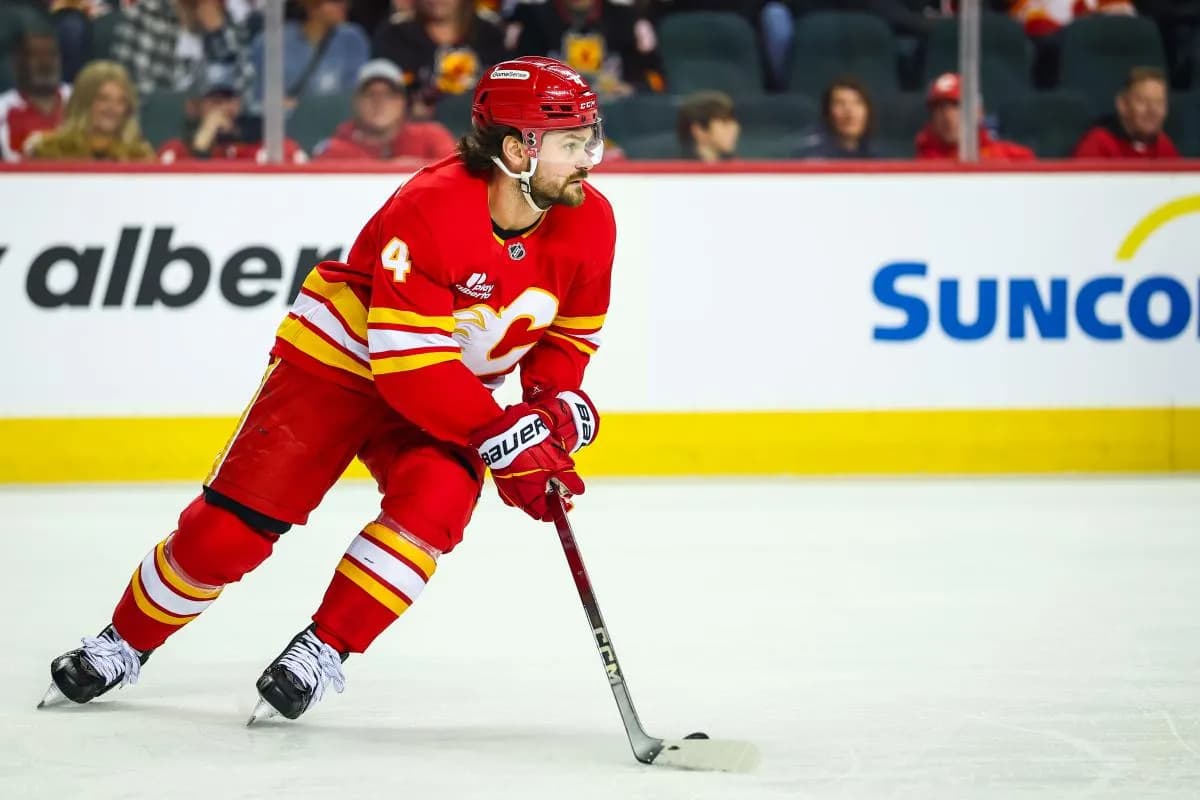 Calgary Flames defenseman Rasmus Andersson (4) skates with the puck against the Winnipeg Jets during the first period at Scotiabank Saddledome.
