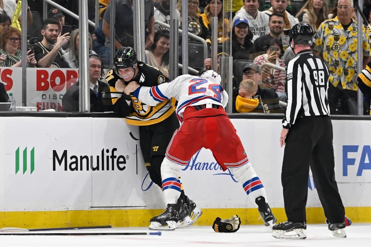New York Rangers defenseman Carson Soucy (24) and Boston Bruins center Michael Eyssimont (81) fight during the second period at TD Garden.