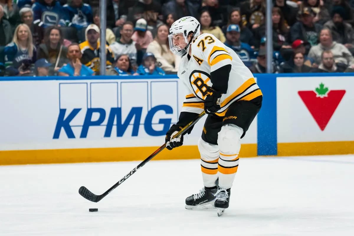 Boston Bruins defenseman Charlie McAvoy (73) handles the puck against the Vancouver Canucks in the third period at Rogers Arena.
