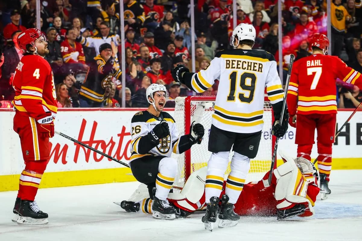 Boston Bruins center Marc McLaughlin (26) celebrates his goal against Calgary Flames goaltender Dustin Wolf (32) during the third period at Scotiabank Saddledome.