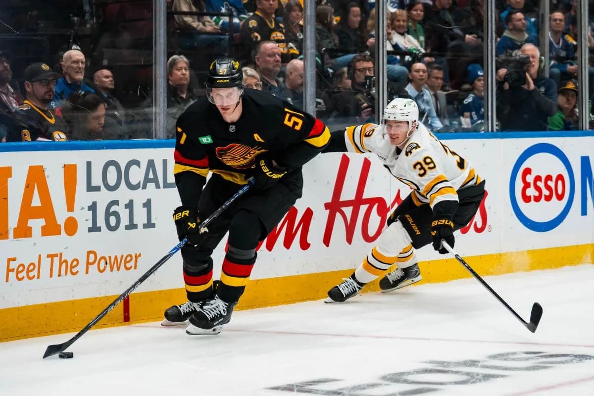 Boston Bruins forward Morgan Geekie (39) pursues Vancouver Canucks defenseman Tyler Myers (57) in the first period at Rogers Arena
