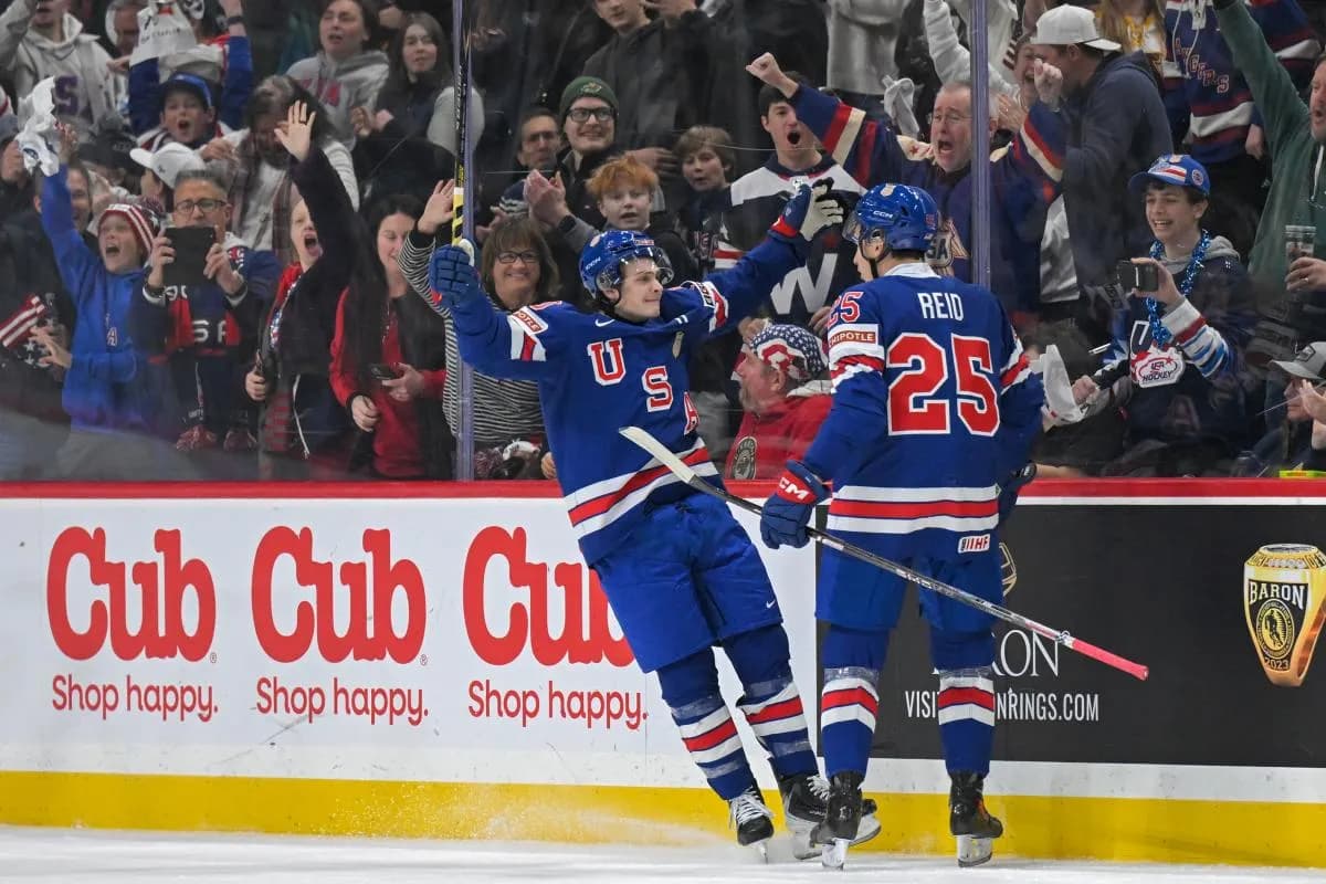 USA defensemen Chase Reid (25) celebrates his power play goal against Sweden with forward James Hagens (10) during the second period in group play during the 2026 IIHF World Junior Championship at Grand Casino Arena.