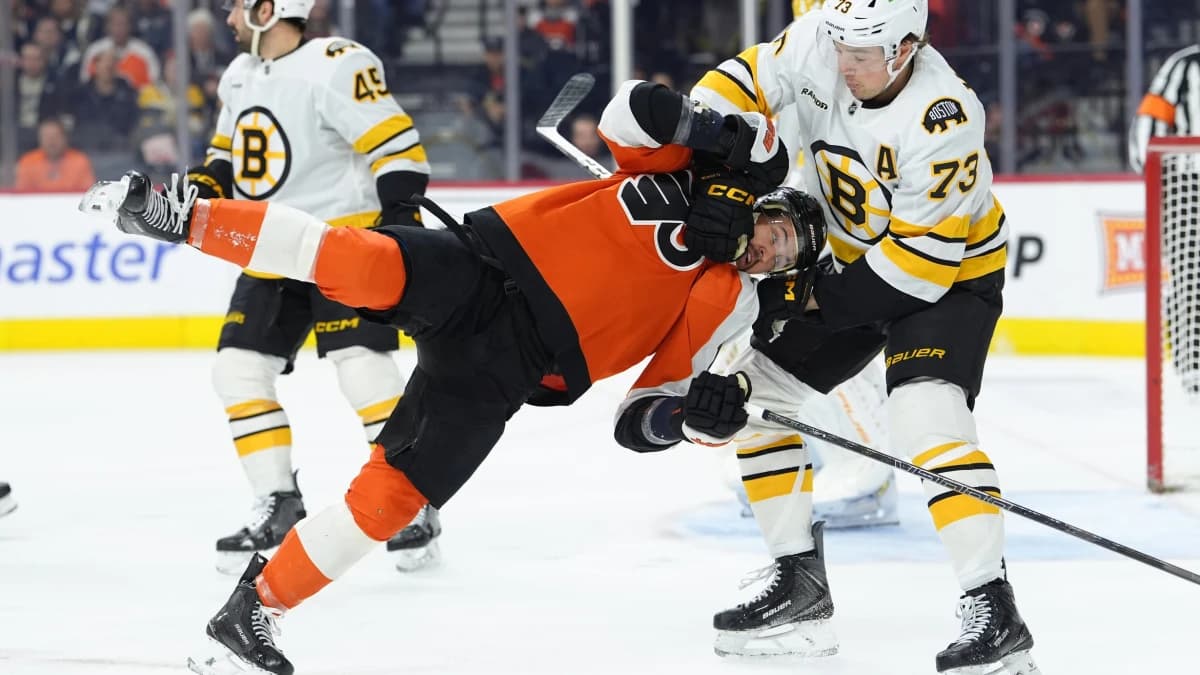 Boston Bruins defenseman Charlie McAvoy (73) grabs Philadelphia Flyers right wing Travis Konecny (11) in the first period at Xfinity Mobile Arena.