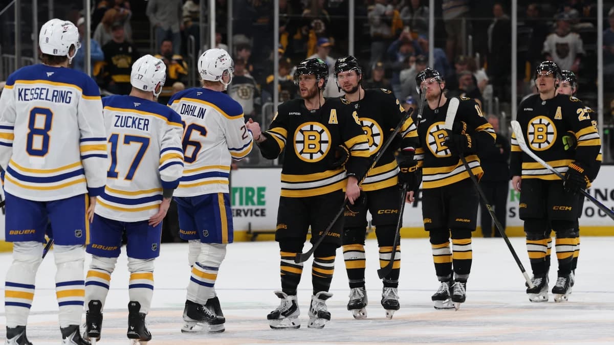 Boston Bruins right wing David Pastrnak (88) leads the Bruins through the Bruins as he shakes hands with Buffalo Sabres defenseman Rasmus Dahlin (26) after game six of the first round of the 2026 Stanley Cup Playoffs at TD Garden.