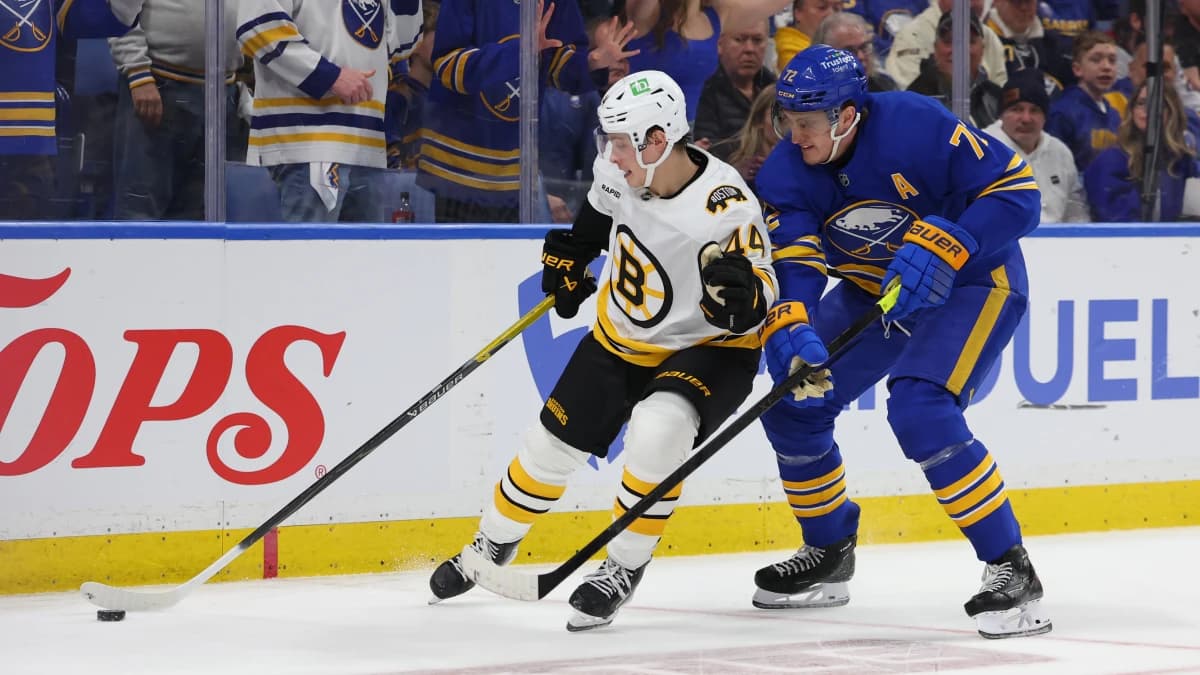 Boston Bruins center James Hagens (44) tries to control the puck as Buffalo Sabres center Tage Thompson (72) defends during the third period in game one of the first round of the 2026 Stanley Cup Playoffs at KeyBank Center.