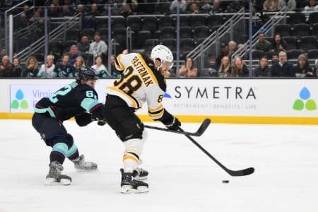 Boston Bruins right wing David Pastrnak (88) plays the puck while Seattle Kraken defenseman Brandon Montour (62) defends during the second period at Climate Pledge Arena.
