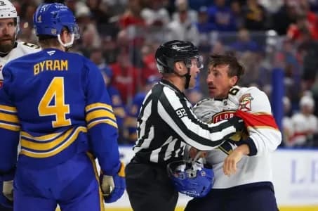 Florida Panthers left wing Brad Marchand (63) gets held back by the linesman during the second period against the Buffalo Sabres at KeyBank Center.