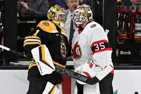 Boston Bruins goaltender Jeremy Swayman (1) talks with Ottawa Senators goaltender Linus Ullmark (35) before a game at TD Garden.