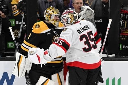Boston Bruins goaltender Jeremy Swayman (1) hugs Ottawa Senators goaltender Linus Ullmark (35) before a game at TD Garden.