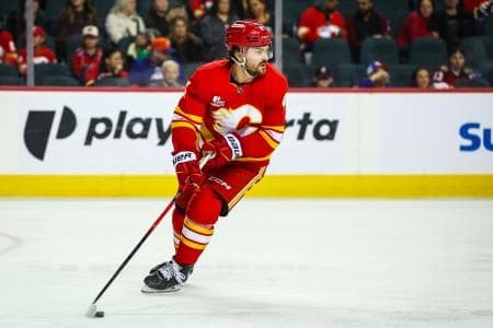 Calgary Flames defenseman Rasmus Andersson (4) skates with the puck against the New York Islanders during the third period at Scotiabank Saddledome.