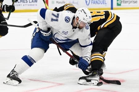 Tampa Bay Lightning center Anthony Cirelli (71) wins a face-off against Boston Bruins center Pavel Zacha (18) during the third period at TD Garden.