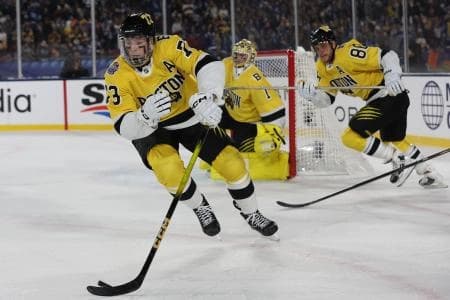 Boston Bruins defenseman Charlie McAvoy (73) controls the puck Tampa Bay Lightning during overtime in the 2026 Stadium Series ice hockey game at Raymond James Stadium.