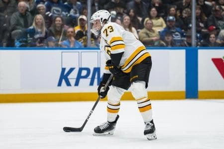 Boston Bruins defenseman Charlie McAvoy (73) handles the puck against the Vancouver Canucks in the third period at Rogers Arena.