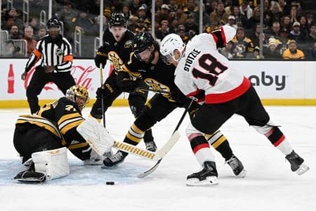 Ottawa Senators center Tim Stützle #18 takes a shot against Boston Bruins goaltender Joonas Korpisalo #70 during the second period at the TD Garden.