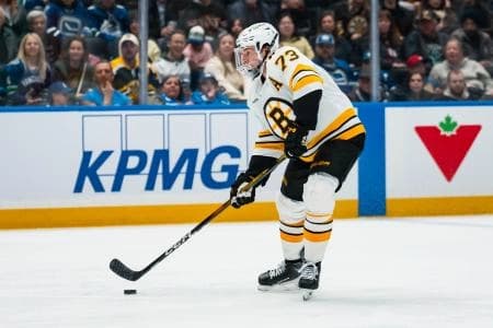 Boston Bruins defenseman Charlie McAvoy (73) handles the puck against the Vancouver Canucks in the third period at Rogers Arena.
