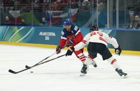 David Pastrnak of Czechia in action with Drew Doughty of Canada in a men's ice hockey group A match during the Milano Cortina 2026 Olympic Winter Games at Milano Santagiulia Ice Hockey Arena.