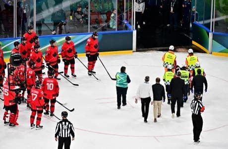 Kevin Fiala of Switzerland is taken off the ice by medical staff on a stretcher after sustaining an injury against Canada in men's ice hockey group A play during the Milano Cortina 2026 Olympic Winter Games at Milano Santagiulia Ice Hockey Arena.