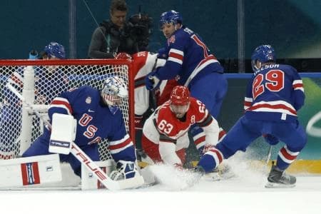 Jeremy Swayman of United States saves a shot from Patrick Russell of Denmark in men's ice hockey group C play during the Milano Cortina 2026 Olympic Winter Games at Milano Santagiulia Ice Hockey Arena.