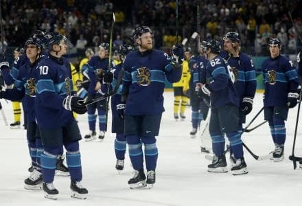 Henri Jokiharju and Nikolas Matinpalo of Finland celebrate after the match against Finland in men's ice hockey group B play during the Milano Cortina 2026 Olympic Winter Games at Milano Santagiulia Ice Hockey Arena.