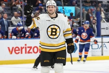Boston Bruins defenseman Andrew Peeke (26) celebrates in the third period against the New York Islanders at UBS Arena.