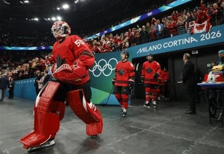 Jordan Binnington (50) of Canada leads the team to the ice to warm up before playing against the United States in the men's ice hockey gold medal game during the Milano Cortina 2026 Olympic Winter Games at Milano Santagiulia Ice Hockey Arena.