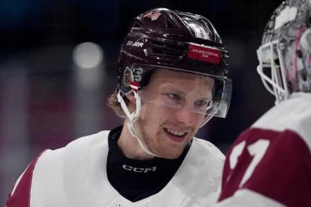 Dans Locmelis of Latvia greets Arturs Silovs of Latvia before their game against Denmark in men's ice hockey group C play during the Milano Cortina 2026 Olympic Winter Games at Milano Rho Ice Hockey Arena