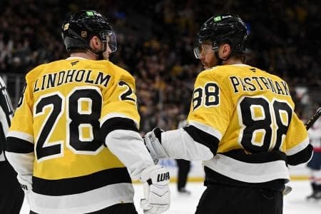Boston Bruins right wing David Pastrnak (88) talks with center Elias Lindholm (28) after a game against the Washington Capitals at the TD Garden.