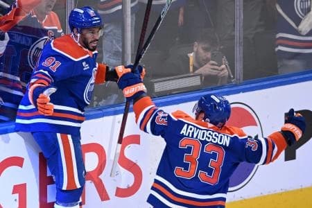 Edmonton Oilers left wing Evander Kane (91) reacts with left wing Viktor Arvidsson (33) after scoring a goal against the Florida Panthers during the first period in game two of the 2025 Stanley Cup Final at Rogers Place