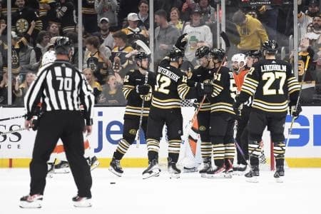 Boston Bruins defenseman Kevin Shattenkirk (12) congratulates defenseman Frederic Brunet (43) after scoring a goal during the second period against the Philadelphia Flyers at TD Garden