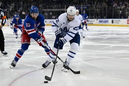 New York Rangers center Mika Zibanejad (93) and Toronto Maple Leafs defenseman Jake McCabe (22) battle for the puck during the second period at Madison Square Garden.