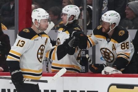 Boston Bruins right wing David Pastrnak (88) congratulates center Charlie Coyle (13) on an empty net goal against the Pittsburgh Penguins during the third period at PPG Paints Arena.