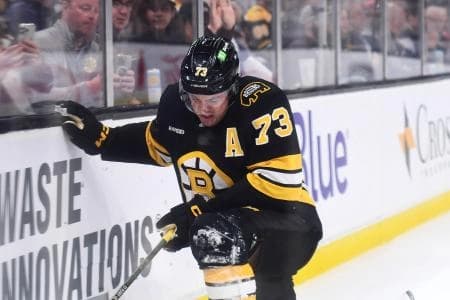 Boston Bruins defenseman Charlie McAvoy (73) is slow to get up after getting tripped into the boards during the second period against the Los Angeles Kings at TD Garden