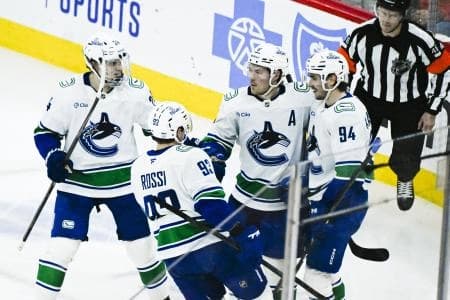 Vancouver Canucks right wing Brock Boeser (6), second from right, celebrates with teammates after scoring a goal against the Chicago Blackhawks during the third period at United Center.