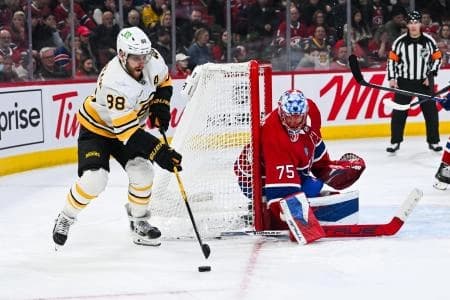 Boston Bruins right wing David Pastrnak (88) plays the puck against Montreal Canadiens goalie Jakub Dobes (75) during the third period at Bell Centre.
