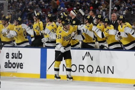 Boston Bruins center Matthew Poitras (51) celebrates a goal against the Tampa Bay Lightning with the bench during the second period in the 2026 Stadium Series ice hockey game at Raymond James Stadium.