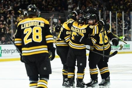 Boston Bruins right wing David Pastrnak (88) left wing Brad Marchand (63) center Pavel Zacha (18) celebrate a goal by center Morgan Geekie (39) during the third period against the Anaheim Ducks at TD Garden