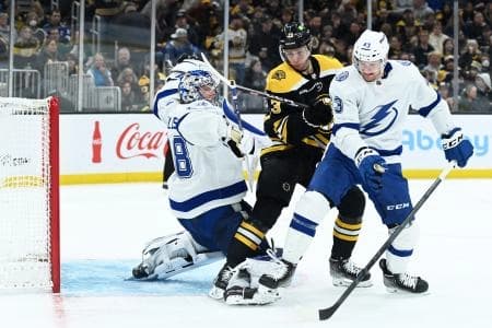 Tampa Bay Lightning defenseman Darren Raddysh (43) and Boston Bruins center Charlie Coyle (13) battle in front of goaltender Andrei Vasilevskiy (88) during the xx period at TD Garden.