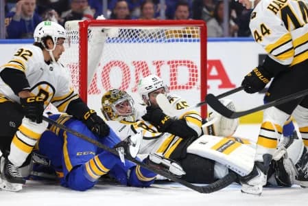Boston Bruins goaltender Jeremy Swayman (1) falls down to cover up the puck during the second period against the Buffalo Sabres in game one of the first round of the 2026 Stanley Cup Playoffs at KeyBank Center.