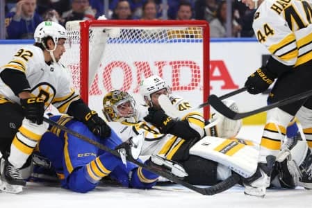 Boston Bruins goaltender Jeremy Swayman (1) falls down to cover up the puck during the second period against the Buffalo Sabres in game one of the first round of the 2026 Stanley Cup Playoffs at KeyBank Center.