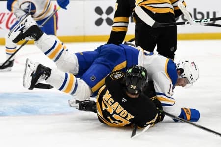 Buffalo Sabres center Peyton Krebs (19) collides with Boston Bruins defenseman Charlie McAvoy (73) during the second period of game three of the first round of the 2026 Stanley Cup Playoffs at the TD Garden.