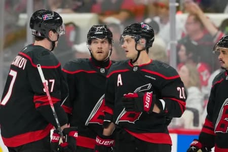 Carolina Hurricanes center Sebastian Aho (20) left wing Nikolaj Ehlers (27) and right wing Andrei Svechnikov (37) talk against the Ottawa Senators during the third period in game one of the first round of the 2026 Stanley Cup Playoffs at Lenovo Center.