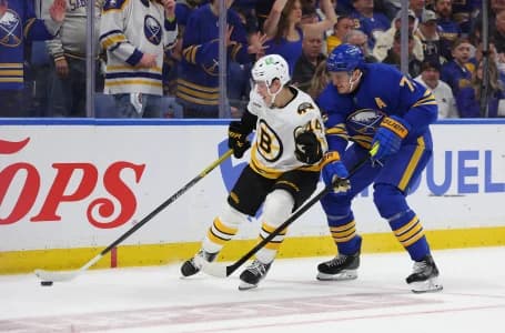 Boston Bruins center James Hagens (44) tries to control the puck as Buffalo Sabres center Tage Thompson (72) defends during the third period in game one of the first round of the 2026 Stanley Cup Playoffs at KeyBank Center.