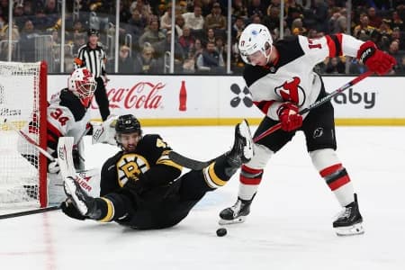 New Jersey Devils defenseman Simon Nemec (17) eyes a loose puck after dumping Boston Bruins center Mark Kastelic (47) during the first period at TD Garden.