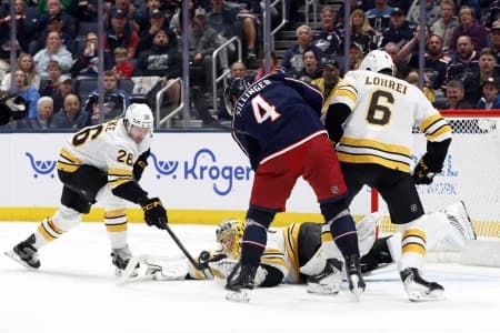Boston Bruins goalie Joonas Korpisalo (70) makes a save as Columbus Blue Jackets center Cole Sillinger (4) looks for a rebound during the third period at Nationwide Arena.