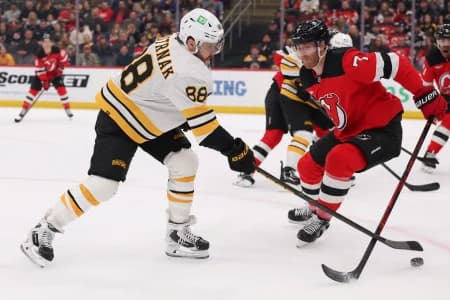 Boston Bruins right wing David Pastrnak (88) and New Jersey Devils defenseman Dougie Hamilton (7) battle for the puck during the first period at Prudential Center.