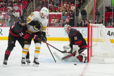 Carolina Hurricanes goaltender Brandon Bussi (32) stops the shot in front of Boston Bruins center Casey Mittelstadt (11) during the second period at Lenovo Center.